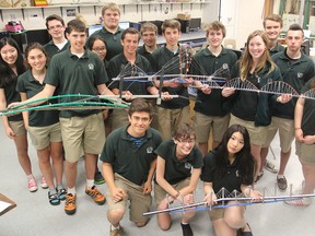 Students in the Grade 11-12 technological design program at Holy Cross Catholic Secondary School gather with the scale models of a possible third crossing bridge they built for a class project. (Michael Lea/The Whig-Standard)
