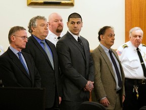Former NFL player Aaron Hernandez stands with his defense attorneys as he hears his verdict in his murder trial at the Bristol County Superior Court in Fall River, Massachusetts, April 15, 2015. Hernandez, 25, a former tight end for the New England Patriots, is convicted of fatally shooting semiprofessional football player Odin Lloyd in an industrial park near Hernandez's Massachusetts home in June 2013. (REUTERS/Dominick Reuter)