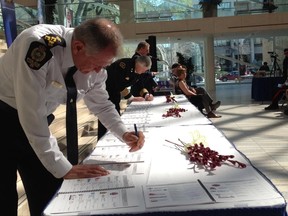 Edmonton Police chief Rod Knecht signs the Community Threat Response and Intervention Support Protocol. Catherine Griwkowsky/Edmonton Sun
