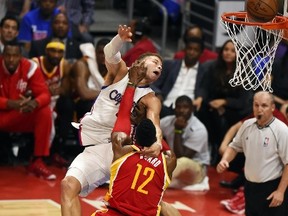 Los Angeles Clippers forward Blake Griffin is fouled by Houston Rockets Dwight Howard during Game Four of their NBA playoffs on  May 10, 2015 at Staples Center in Los Angeles, California. (AFP PHOTO/ROBYN BECK)