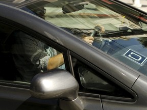 The logo for Uber is shown on a vehicle. (REUTERS/Robert Galbraith)