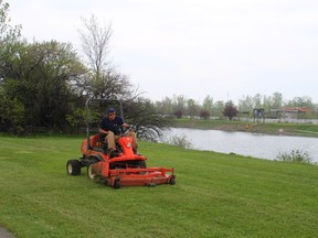 In this file photo, WRCC seasonal worker Ethan Mosley cuts the grass along the banks of the recreational canal. As the City of Welland takes over the WRCC, the question of how much it will cost to maintain the lands was recently raised at council.