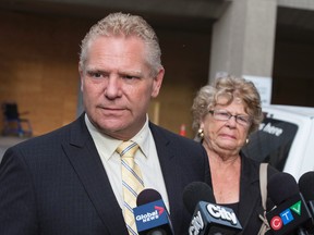 Doug Ford and mother Diane Ford update the media on Rob Ford's cancer surgery outside Mount Sinai Hospital in Toronto Monday May 11, 2015. (Craig Robertson/Toronto Sun)