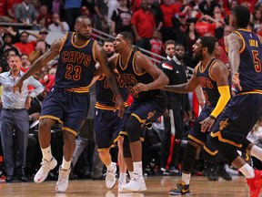 Cavaliers’ LeBron James (left) celebrates with teammates after scoring the game-winning basket against the Bulls as time expired in Game 4. (USA TODAY)