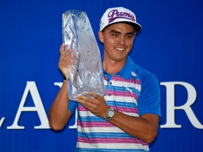 Rickie Fowler holds up The Players Championship trophy after winning the tournament on Sunday, May 10, 2015. (John David Mercer/USA TODAY Sports)
