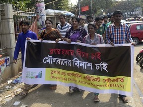 Members of Blogger and Online Activist Network march in the street during a protest against the killing of US blogger of Bangladeshi origin, Avijit Roy -  founder of Mukto-Mona (Free-mind) blog site - who was hacked to death by unidentified assailants, in Dhaka on February 27, 2015.  
AFP PHOTO / Munir uz ZAMAN