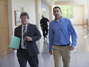Andrew Biddle, right, exits the Atlantic County Courthouse with attorney Mark Roddy in Mays Landing, New Jersey on May 12, 2015. Biddle is facing charges of conspiracy and the theft by deception after allegedly faking his own death in July 2014.  He pleaded not guilty at the arraignment.  REUTERS/Mark Makela