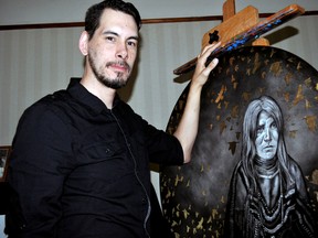 Local artist Sean Couchie next to one of his paintings, Broken Circle, on May 8, 2015 in London Ont. CHRIS MONTANINI\LONDONER\POSTMEDIA NETWORK