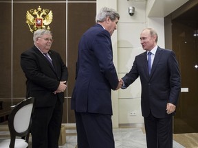 U.S. Secretary of State John Kerry (C) shakes hands with Russia's President Vladimir Putin as U.S. Ambassador to Russia John Tefft (L) watches at the presidential residence of Bocharov Ruchey in Sochi, Russia May 12, 2015. (REUTERS/Joshua Roberts)