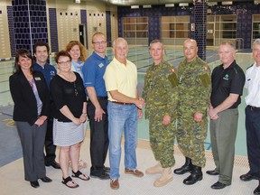 Representatives from Kingston Military Resources Centre, CFB Kingston Personal Support Services and Boy and Girls Club of Kingston pose for a photo in the newly opened Aquatics Centre at the Boys and Girls West club in Kingston on Tuesday. The partnership will see the military groups run the pool and share the space and facilities with their personnel and the Boys and Girls Club youth members. (Julia McKay/The Whig-Standard)