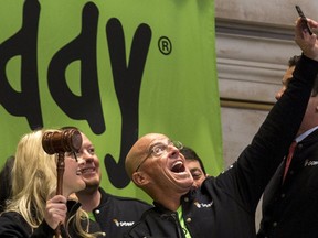 GoDaddy chief executive officer Blake Irving takes a selfie with a customer before they ring the opening bell to celebrate his web hosting company GoDaddy's IPO on the floor of the New York Stock Exchange April 1, 2015.  REUTERS/Brendan McDermid