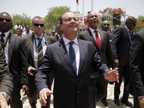 French President Francois Hollande, centre, and Haiti's President Michel Martelly, second from right, greet guests after their speeches at National Palace in Port-au-Prince, May 12, 2015. French President Francois Hollande pledged to pay back a "moral debt" to Haiti during a visit on Tuesday. His visit marked the first official visit by a French president to the hemisphere's poorest country. REUTERS/Andres Martinez Casares