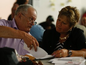 Keith Lancaster, a resident of 200 Wellesley St. E., speaks with Toronto Sun columnist Sue-Ann-Levy at the first of four public forums called the Mayor's Task Force on Toronto Housing held at 519 Community Centre on Church St. Monday May 12, 2015. (Jack Boland/Toronto Sun)