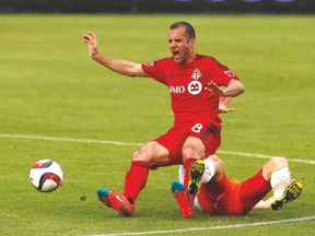 TFC’s Benoit Cheyrou is taken down during Sunday’s loss to the Houston Dynamo at BMO Field. (MICHAEL PEAKE/Torotno Sun)