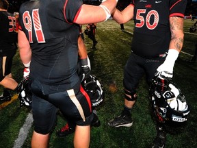 Eskimos GM Ed Hervey was surprised that Danny Groulx, right, shown here following a victory over the Montreal Carabins in November 2013, was still available at the seventh pick in this year's draft. (Postmedia Network file)