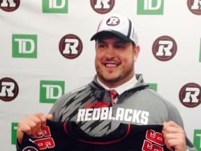Alex Mateas smiles after being selected by the RedBlacks with the first overall pick at the CFL Draft on Tuesday, May 12, 2014. (Tim Baines/Postmedia Network)