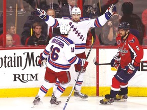 Capitals forward Alex Ovechkin skates away while Rangers’ Rick Nash and Derick Brassard celebrate during Game 6 on Sunday. (USA TODAY SPORTS)