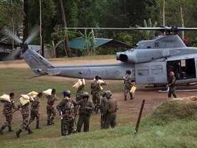 Nepalese service members load relief supplies into a U.S. Marine Corps UH-1Y Venom from Joint Task Force 505 at Sindhuli, Nepal in this May 11, 2015 photo.  REUTERS/Hernan Vidana/U.S. Marine Corps photo/Handout