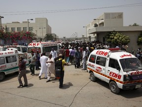Ambulances and people gather outside the hospital after an attack on a bus in Karachi, Pakistan, May 13, 2015. Gunmen on motorcycles opened fire on a bus in Pakistan's southern city of Karachi on Wednesday, killing at least 43 people, police said. (REUTERS/Akhtar Soomro)