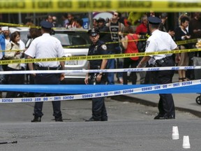 Members of the NYPD police stand near the crime scene as a hammer (pictured left on the ground) lies on the ground, at the intersection of 37th street and 8th avenue in midtown Manhattan in New York, May 13, 2015.  A hammer-wielding man who hit three people on the head in tourist-packed areas of New York City earlier this week has been shot in a confrontation with police, New York media reported on Wednesday.  REUTERS/Shannon Stapleton