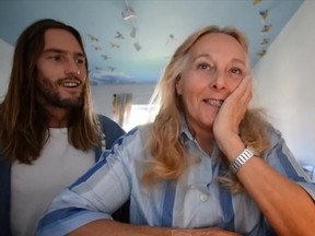Alex Lyngaas, left, shows his mother Eva the video he made for her to find love. (YouTube/screen grab)