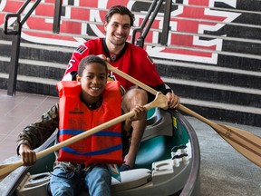 Ottawa Senators Cody Ceci and Camp Smitty camper A.J. Osman smile as they pretend to paddle a canoe following a press conference at the Canadian Tire Centre on Wednesday May 13, 2015. The Ottawa Senators Foundation announced a $200,000 SENS Campership Program to send more than 1,100 children to camps this summer. Errol McGihon/Ottawa Sun/Postmedia Network