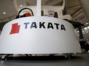 A logo of Takata Corp is seen with its display at a showroom for vehicles in Tokyo, Japan, May 8, 2015. Japan's Takata Corp said on Friday it expects to post a return to profit this fiscal year, emerging from a massive global recall crisis surrounding its exploding air bags. (REUTERS/Yuya Shino)
