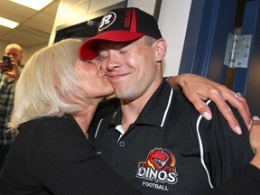 University of Calgary Dinos Jake Harty is kissed by mom Kim after he was picked by the Ottawa RedBlacks in the second round of the CFL draft on Tuesday May 12, 2015. Jim Wells/Postmedia Network