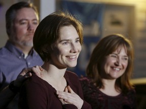 Amanda Knox talks to the press surrounded by family outside her mother's home in Seattle, Washington March 27, 2015. Italy's top court on Friday annulled the conviction of American Amanda Knox for the 2007 murder of British student Meredith Kercher and, in a surprise verdict, acquitted her of the charge. The Court of Cassation threw out the second guilty verdict to have been passed on Knox, 27, and her Italian former boyfriend Raffaele Sollecito for the lethal stabbing.  REUTERS/Jason Redmond