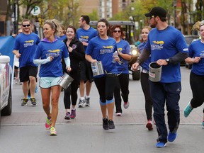 LUKE HENDRY/THE INTELLIGENCER
Participants in the Law Enforcement Torch Run for Special Olympics, including Belleville Police Sgt. Sheri Meeks, centre left, run south down Front Street in Belleville, Wednesday. He's one of more than 170 Special Olympics athletes in the Quinte region.