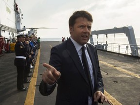 Italy's Prime Minister Matteo Renzi gestures onboard the naval ship San Giusto off the coast of Sicily, Italy, April 27, 2015. United Nations Secretary-General Ban Ki-moon and EU Foreign Policy Chief Mogherini joined Renzi on Monday for a flying visit to the Italian Naval vessel San Giusto off the coast of Sicily to observe Italian efforts undertaken to save the lives of migrants crossing the Mediterranean Sea. Italian vessels, together with private merchant ships, are dealing with the emergency caused by mass departures from Libya with over 25,000 people reported to have landed this year. Picture taken April 27, 2015.  REUTERS/Palazzo Chigi Press Office/Handout