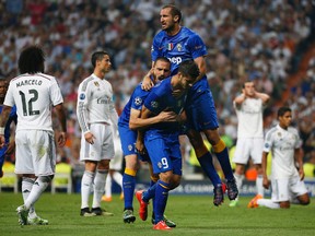 Juventus' Alvaro Morata celebrates scoring their first goal with Leonardo Bonucci and Giorgio Chiellini. (Reuters/Sergio Perez)