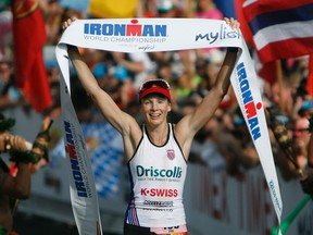 Leanda Cave of Britain celebrates after winning the Ironman World Championship triathlon in Kailua-Kona, Hawaii, on Oct. 13, 2012. U.S. prosecutors allege the Ironman Triathlon race charged athletes illegally for a chance to compete in its world competition. (Hugh Gentry/Reuters/Files)