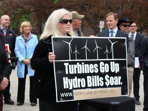 Lorrie Gillis joins other protesters on the front lawn of Queen's Park Wednesday, May 13, 2015 to vent their concerns over rising hydro prices. (Antonella Artuso/Toronto Sun)