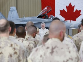 Canada's Prime Minister Stephen Harper is seen here delivering a speech to soldiers at the Camp Patrice Vincent section of a military base in Kuwait May 3, 2015. The PM confirmed in question period on May 13 that the Canadian Forces will implement all 10 recommendations from an external review of sexual misconduct. REUTERS/Chris Wattie