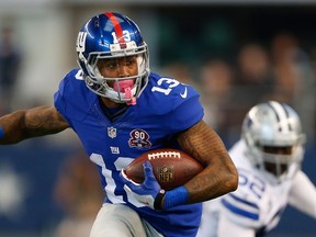 Odell Beckham Jr. of the New York Giants carries the ball after the catch against the Dallas Cowboys in the first half at AT&T Stadium on October 19, 2014. (Wesley Hitt/Getty Images/AFP)