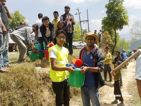 The Rotary Club of Dhulikhel and Rotary Community Corps Simalchaur, along with other organizations, supported 100 relief aid buckets to families in Phoolbari, Nepal. More packages have since been distributed to villagers. (Supplied photo)