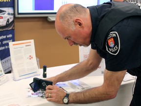 Const. Greg Harbec demonstrates the Trace pen at Kingston Police Headquarters on Wednesday. (Steph Crosier/The Whig-Standard)
