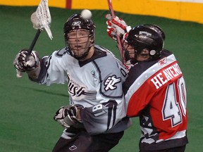 Nolan Heavenor (R) from the Calgary Roughnecks goes up against Jimmy Quinlan from the Edmonton Rush in Lacrosse action at the Pengrowth Saddledome in downtown Calgary.