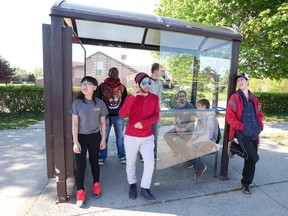 Members of Youth Organizing Leadership Opportunities, Jessy Qin, left, Joseph Chakabveyo, Yousef Hashim, Jake Rice, Michael Adam, Calvin Thomson and Curtis Hiscox, will will survey participants after their walk-throughs of a city bus. (DEREK RUTTAN, The London Free Press)