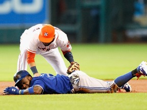 Jose Reyes of the Toronto Blue Jays is tagged out my Marwin Gonzalez of the Houston Astros on Aug. 3, 2014. (Getty/AFP)