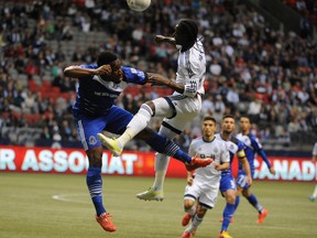 Whitecaps forward Darren Mattocks goes up for a header against an FC Edmonton defender during the first half Wednesday at BC Place. (USA TODAY SPORTS)