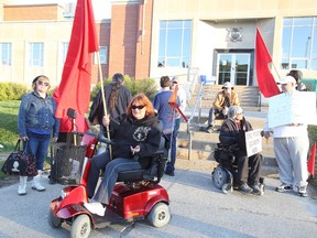 About a dozen members of The Sudbury Revolutionary Network held a rally to protest against what it says are inequalities in the legal system in front of the courthouse in Sudbury, Ont. on Wednesday May 13, 2015. Gino Donato/Sudbury Star/Postmedia Network