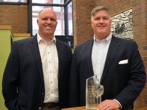 Darren, left, and Dan Reith with the award Reith and Associates recently won. The St. Thomas Insurance and Financial Services company was named the Brokerage of the Year by the Insurance Brokers Association of Ontario.