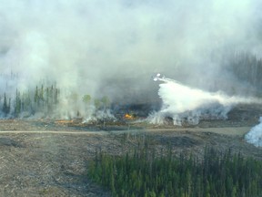 A plane douses the fire at Little Bobtail Lake with water. British Columbia/Wildfire Management Branch