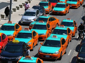Over 100 Cabs take over the streets around City Hall to protest of Uber as they urge the city to put the ride sharing service out of business in Toronto on Thursday May 14, 2015. (Dave Abel/Toronto Sun)