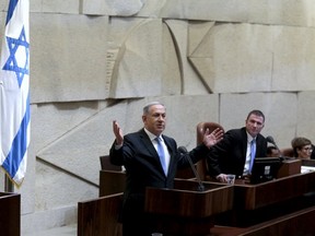 Israeli Prime Minister Benjamin Netanyahu delivers a speech in the Knesset, the Israeli parliament, before his new government is sworn in following the mid-March general elections, in Jerusalem May 14, 2015.  REUETRS/Jim Hollander/Pool