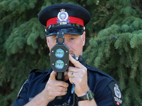 Edmonton Police Service Cst. David Debler does traffic enforcement near Saskatchewan Drive and University Avenue, in Edmonton, Alta. on Thursday May 14, 2015. May 12 to 18 marks Canada Road Safety Week. David Bloom/Edmonton Sun/Postmedia Network