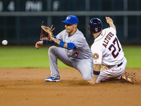 Astros second baseman Jose Altuve (right) slides safely with a stolen base as Blue Jays shortstop Ryan Goins (left) fields the ball during first inning MLB action in Houston on Thursday, May 14, 2015. (Troy Taormina/USA TODAY Sports)