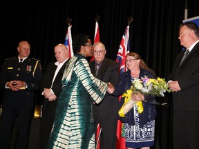 Paula Wharton is congratulated by members of Nicole Belair's family on Thursday. The Greater Sudbury Police Service held its first Shared Commitment awards banquet last night. The Nicole Belair Service Above Self Award was awarded  as well as nine others. Gino Donato/Sudbury Star